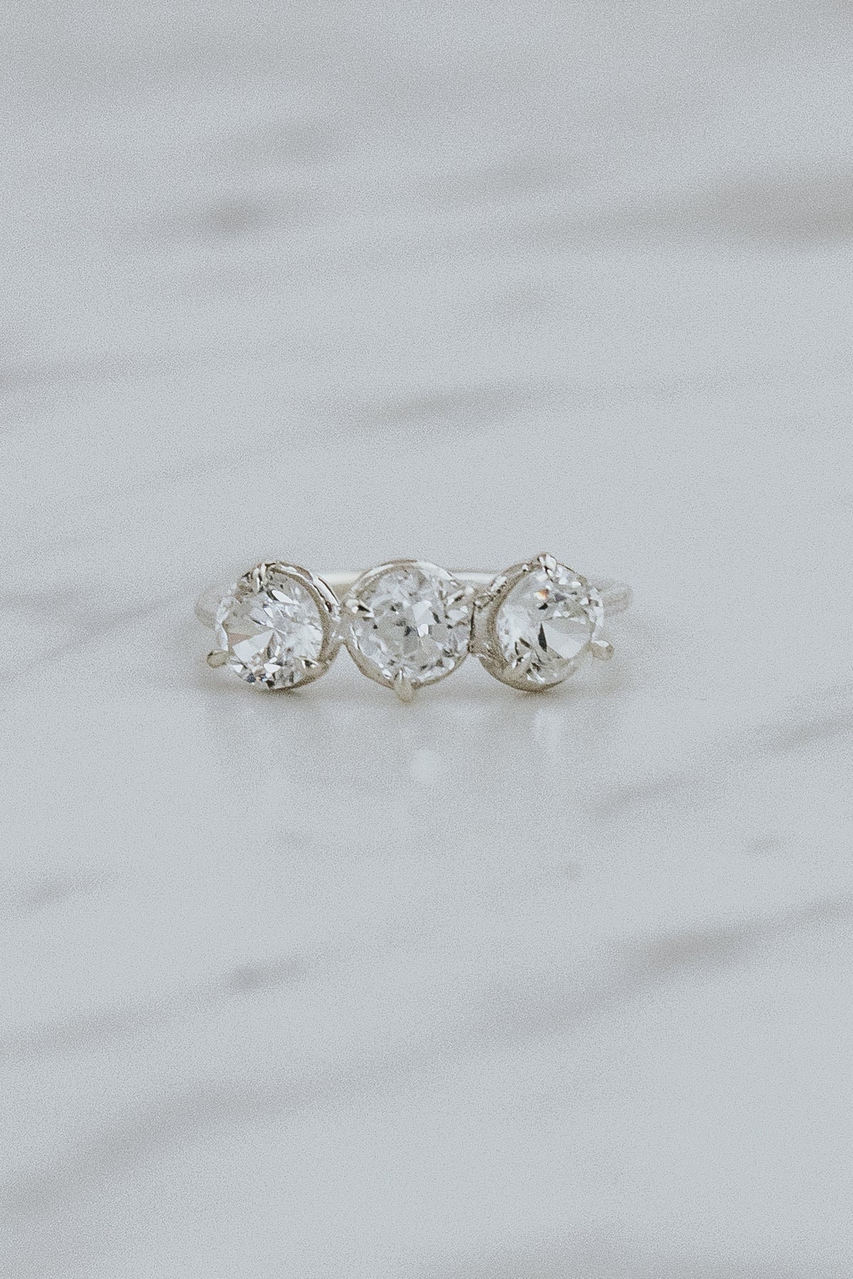 Wings Hawaii Triplet Ring with Clear Zircon gemstones in sterling silver. Fine jewelry handcrafted in Maui. Number three symbolic jewelry gift. 