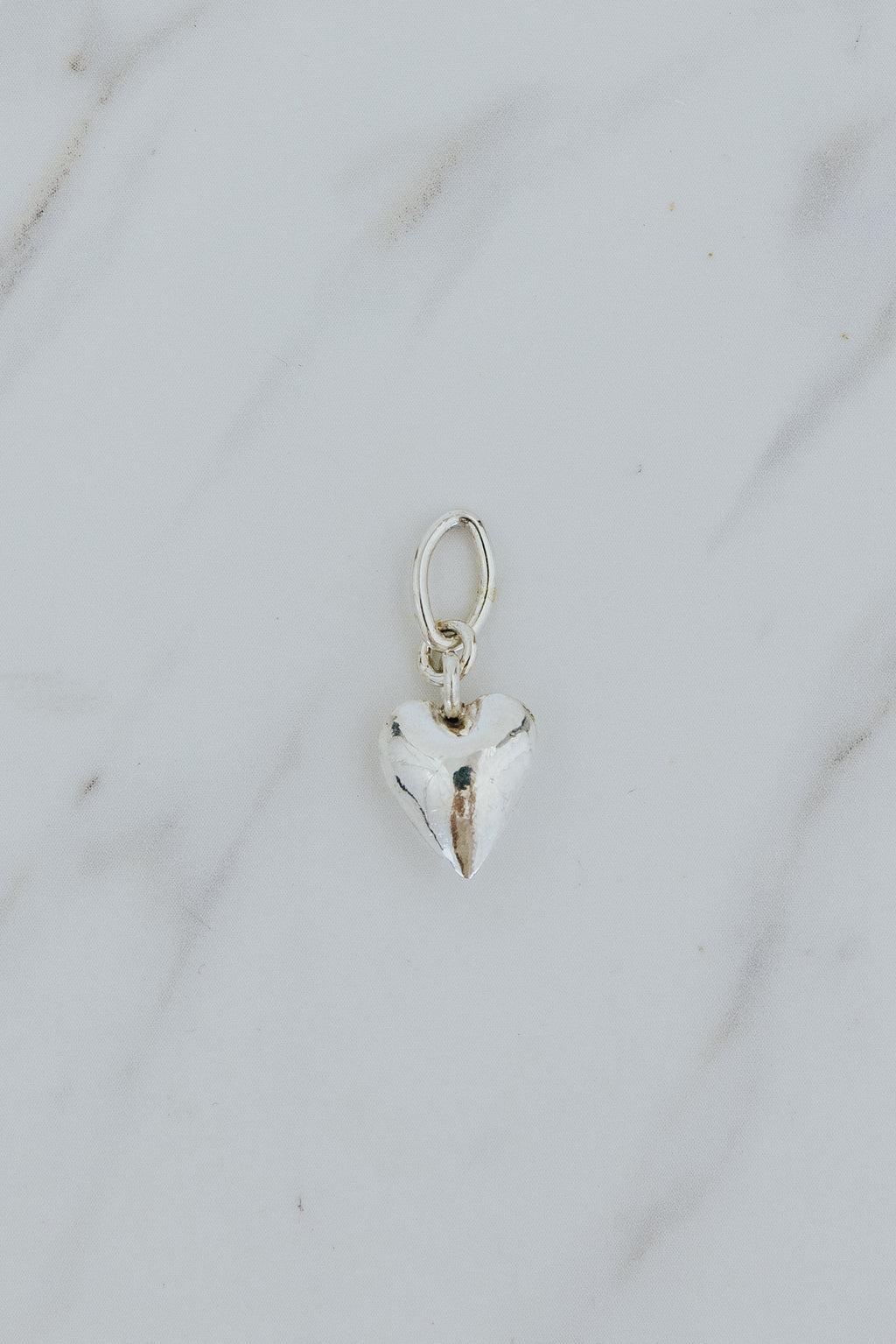 Wings Hawaii puffed heart necklace charm in sterling silver. Fine jewelry expertly handcrafted in Maui. Modern charm necklaces made in Hawaii. 