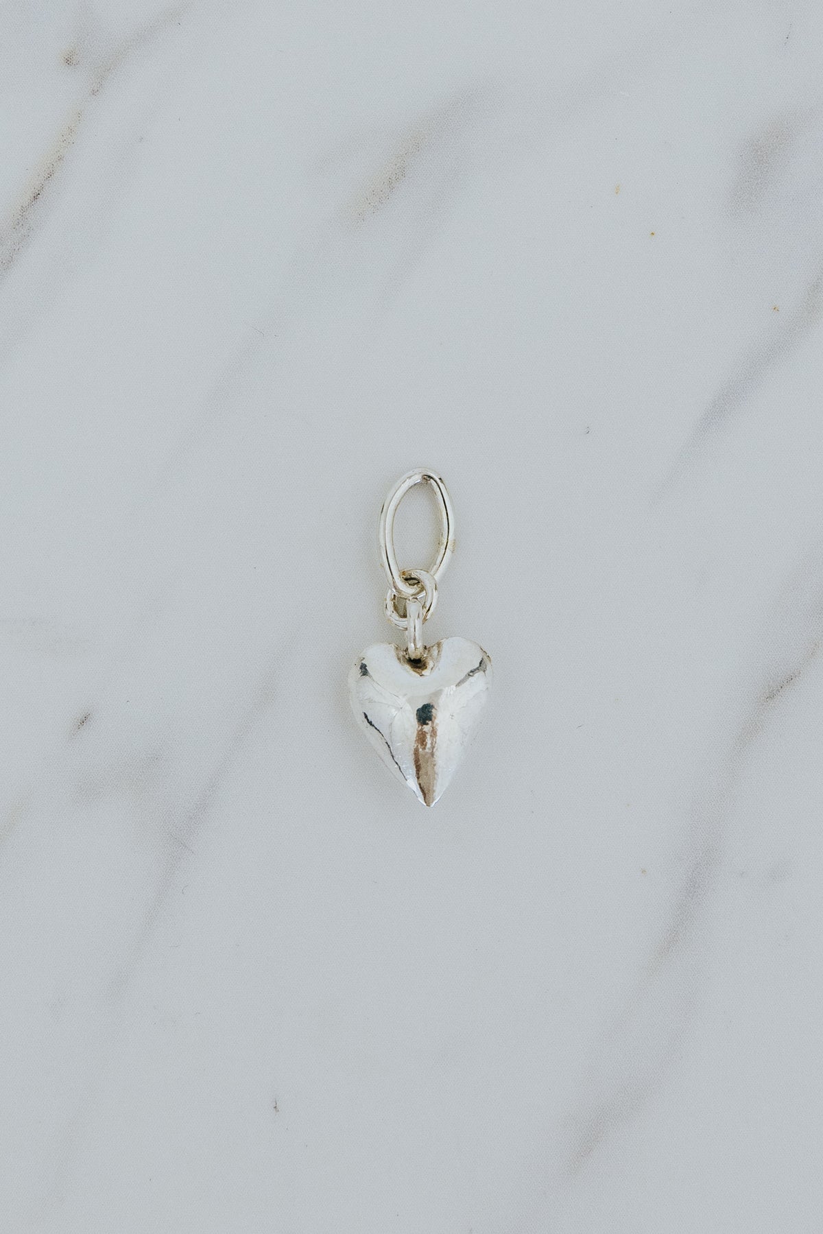 Wings Hawaii puffed heart necklace charm in sterling silver. Fine jewelry expertly handcrafted in Maui. Modern charm necklaces made in Hawaii. 