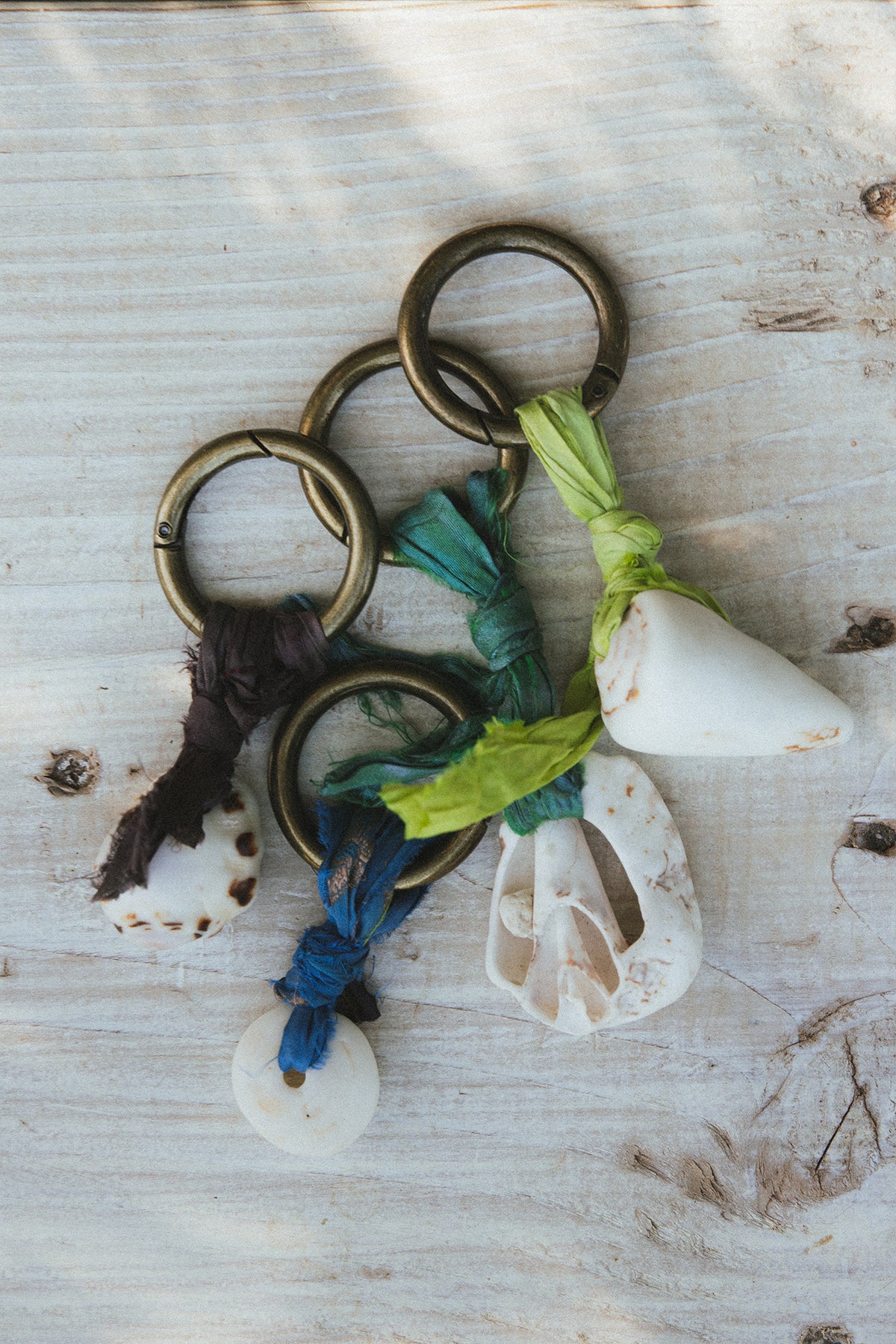 Wings Hawaii Shell Purse Charms Keychains with real Hawaiian beach shells and jewel tone braided silk ribbon on a brass ring. Handmade in Maui. Great gift or island souvenir. 