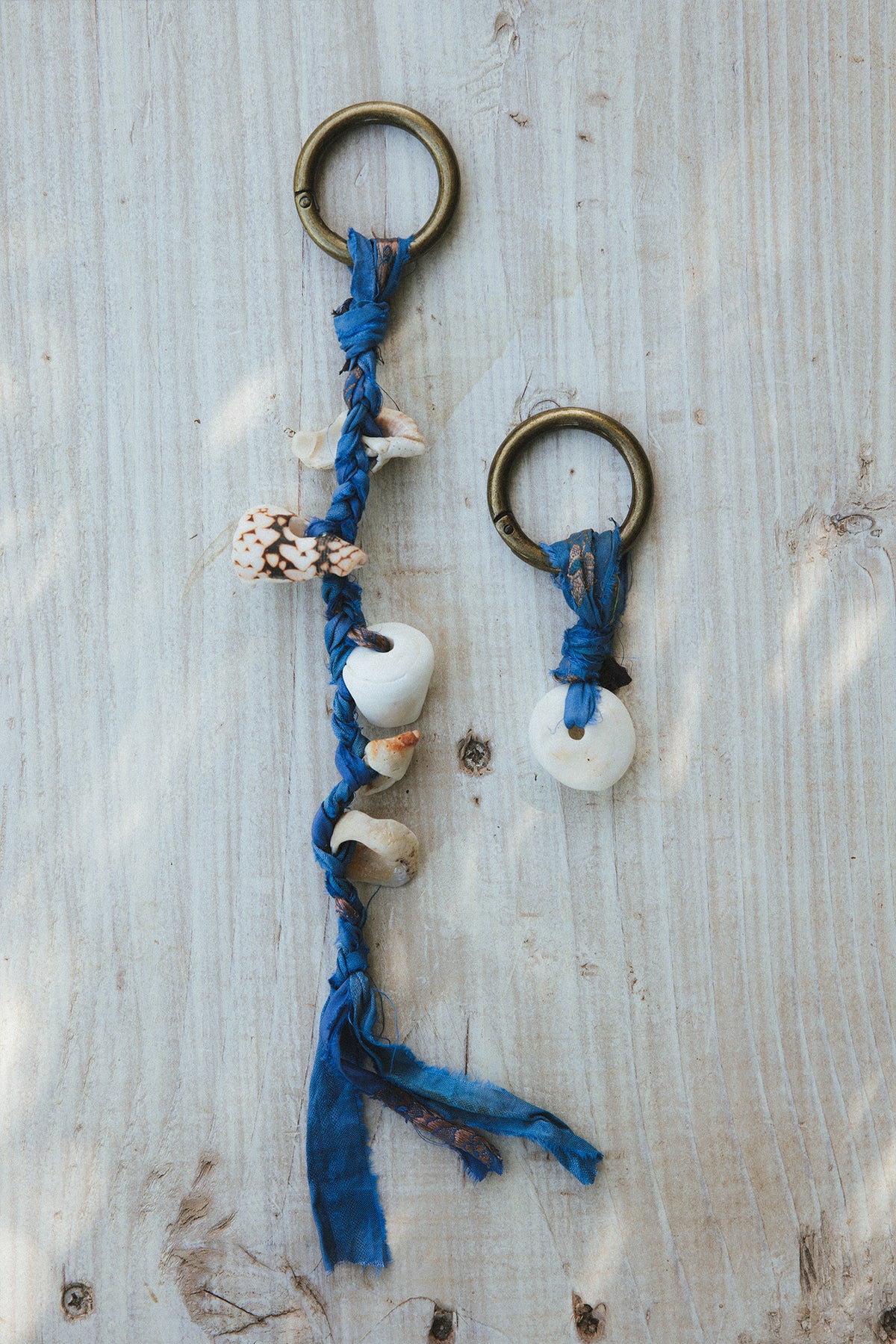 Wings Hawaii Shell Purse Charms Keychains with real Hawaiian beach shells and jewel tone braided silk ribbon on a brass ring. Handmade in Maui. Great gift or island souvenir. 