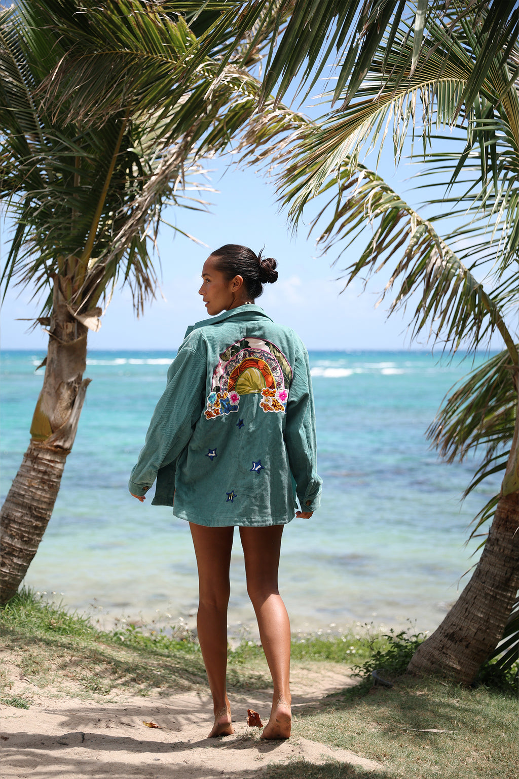 Wings Hawaii Rainbow Field Jacket. Teal blue oversized corduroy jacket with rainbow design in upcycled aloha fabric. Handmade and hand-sewn in Haiku, Maui. Perfect beach coverup or winter layer. 