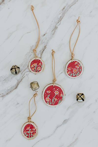 Wings Hawaii birch wood ornaments with hand-painted flowers, red background, leather loop 