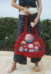 Wings Hawaii patched up cotton duffel bag in red. Original artwork on embroidered patches - mermaids, surfer girls, whales, tigers, rainbows and more. Handmade with aloha in Maui. 