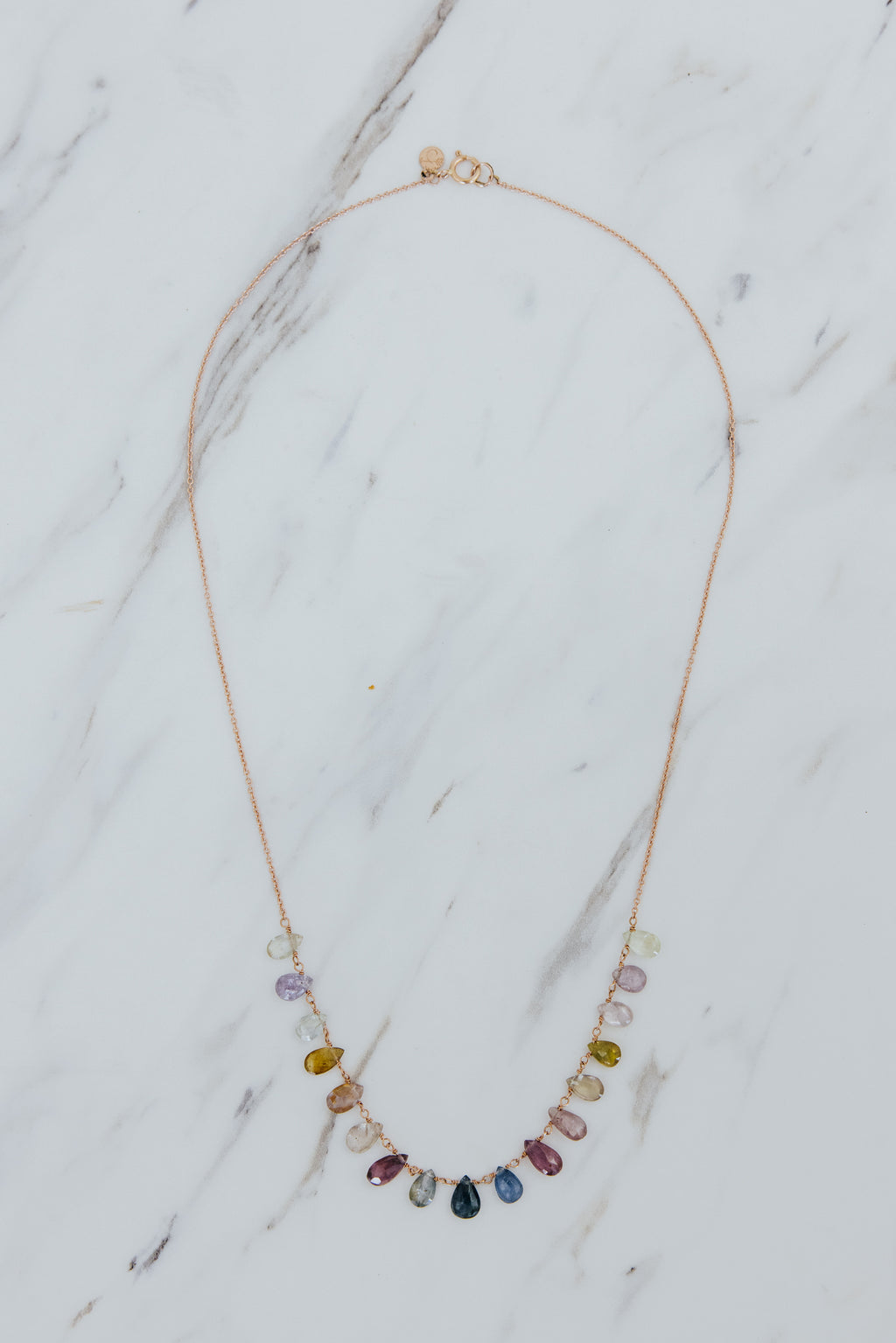 Wings Hawaii sapphire crown jewels necklace in 14k rose gold. A rainbow display of various Sapphire gemstone hues. Fine jewelry handmade in Maui. Unique handcrafted gifts from Hawaii. 