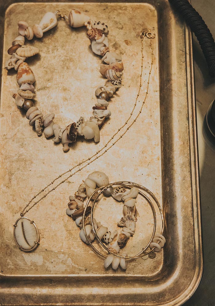 Shell necklaces on a gold tray