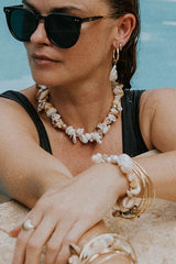 model wearing Wings Hawaii shell pile necklace and bracelet thumbnail