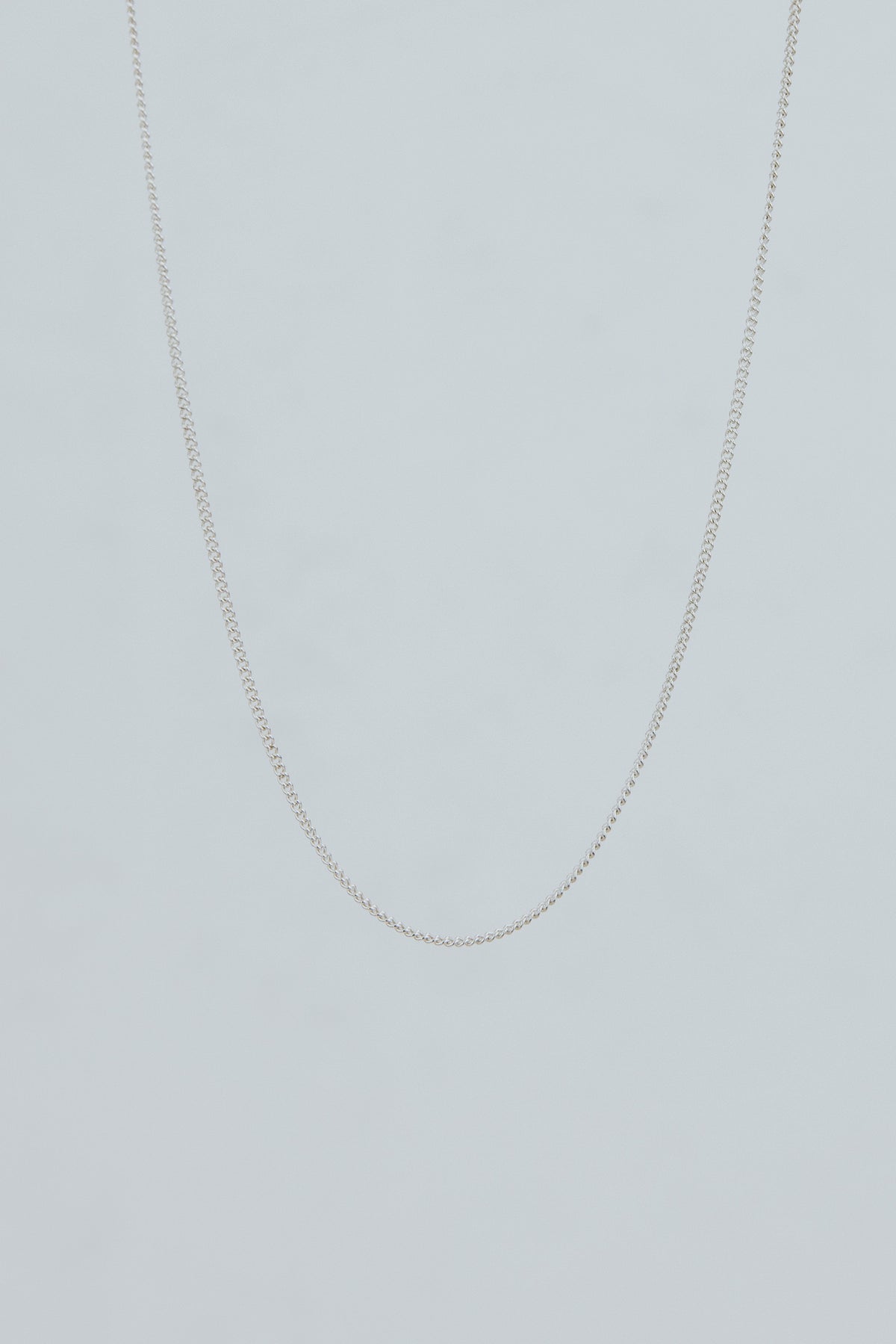 Wings Hawaii delicate 1.2mm curb chain necklace in sterling silver. 17" length. Fine jewelry handcrafted with aloha in Maui. Wear solo, layered, or add charms to customize. High quality jewelry made in Hawaii. 