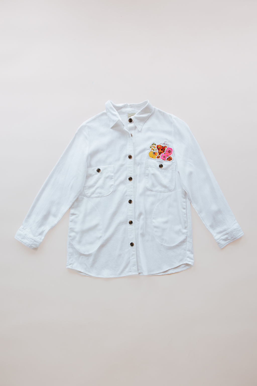 Wings Hawaii sun + moon linen blouse in white. Long sleeve shirt with side pockets. Handmade and upcycled with vintage aloha fabrics. Handcrafted in Maui with aloha. Small batch, sustainable, high quality women's apparel made in Hawaii. 