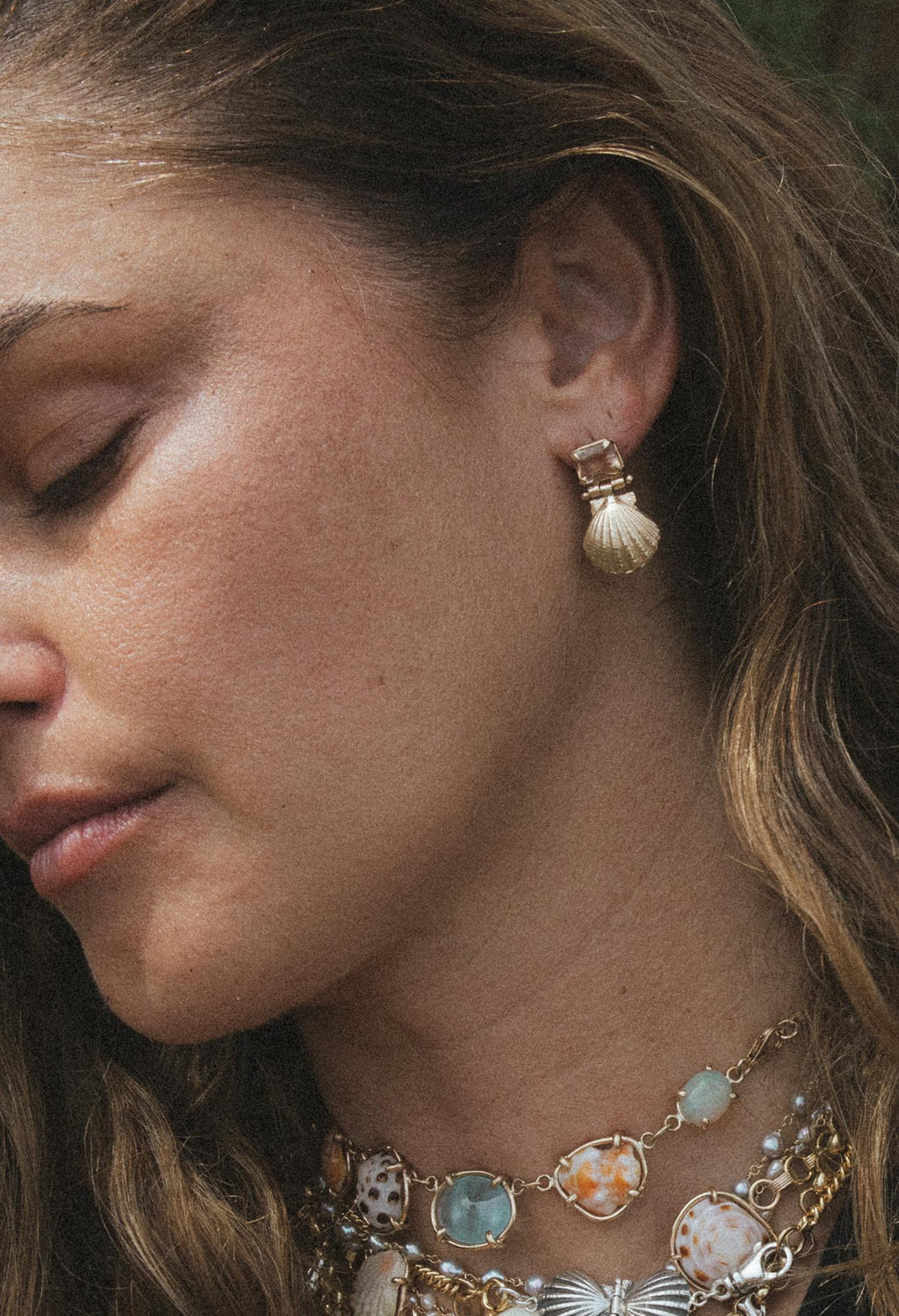 Wings Hawaii Siren Solstice Earrings with Red Schiller Sunstones and Sunrise Shells in solid 14k gold. Hinged for unique movement. Fine jewelry expertly handcrafted in Maui. 