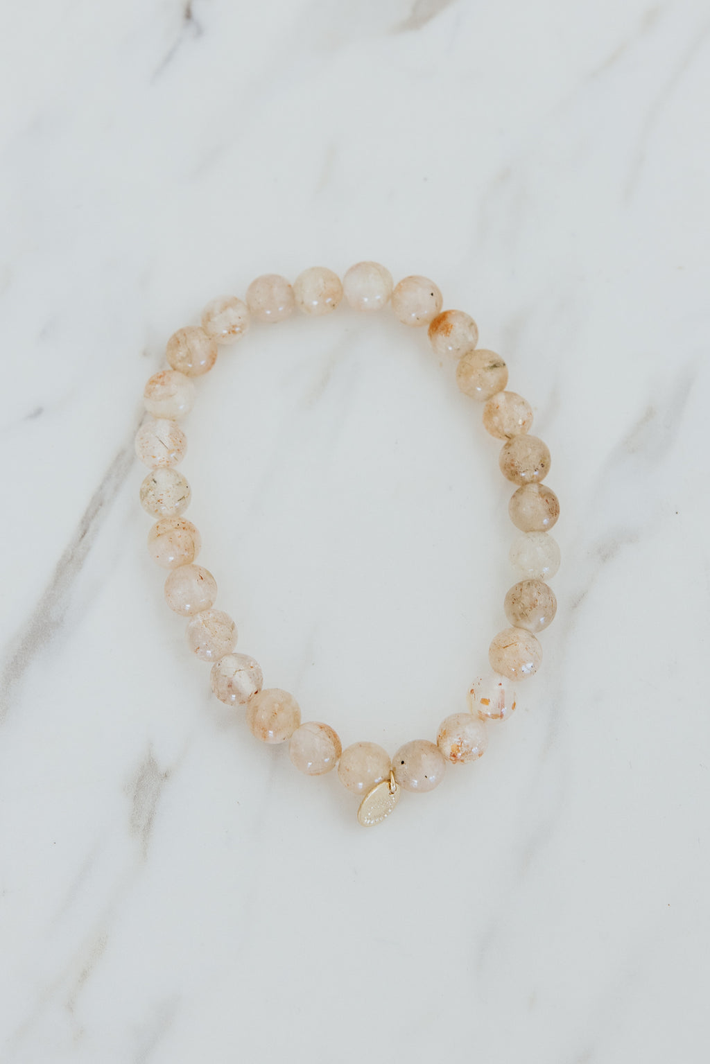 Wings Hawaii Sunstone stretchy beaded bracelet with 14k gold-filled tag. Crystal chakra healing. Boho-chic spiritual jewelry handmade in Maui.