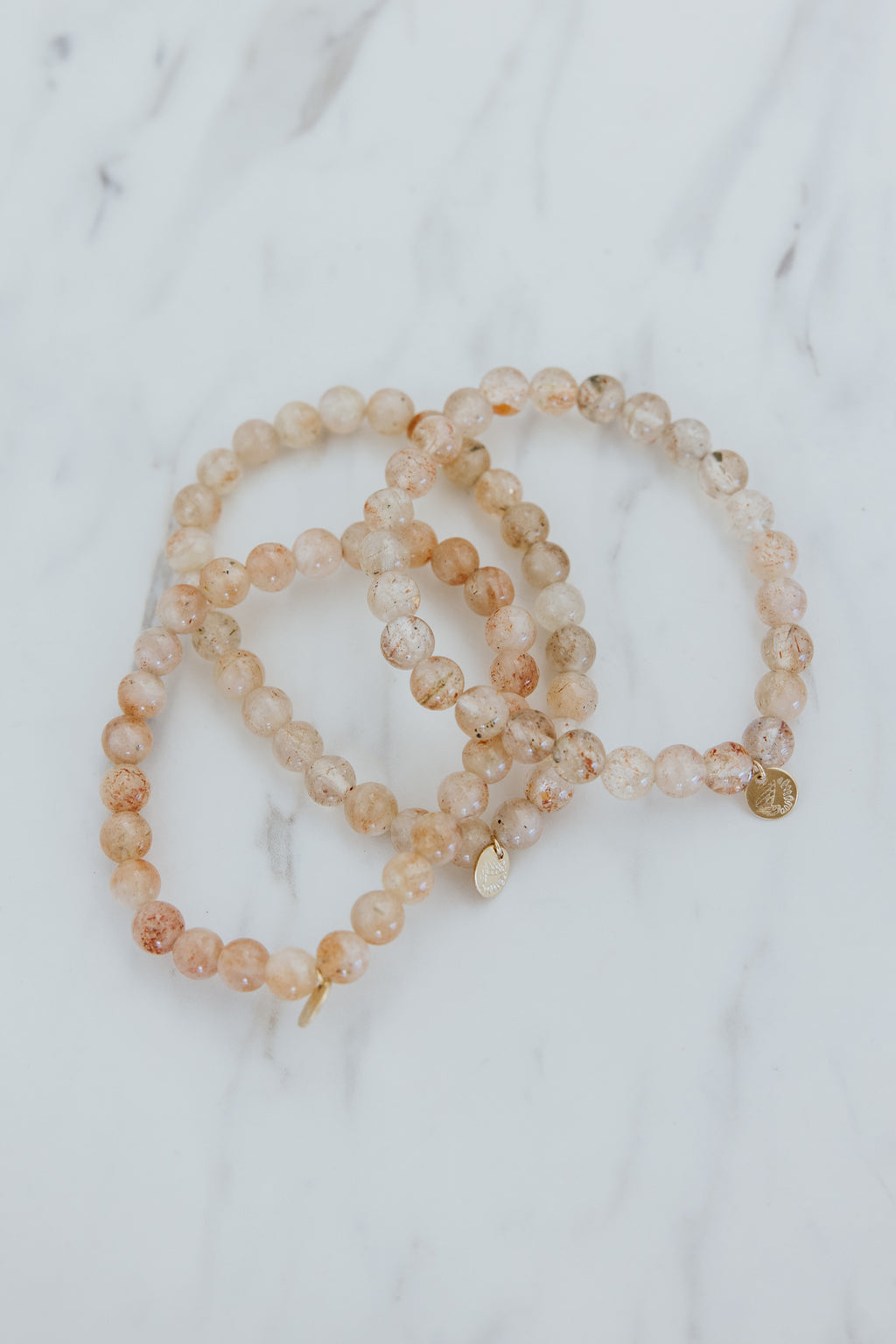 Wings Hawaii Sunstone stretchy beaded bracelet with 14k gold-filled tag. Crystal chakra healing. Boho-chic spiritual jewelry handmade in Maui.