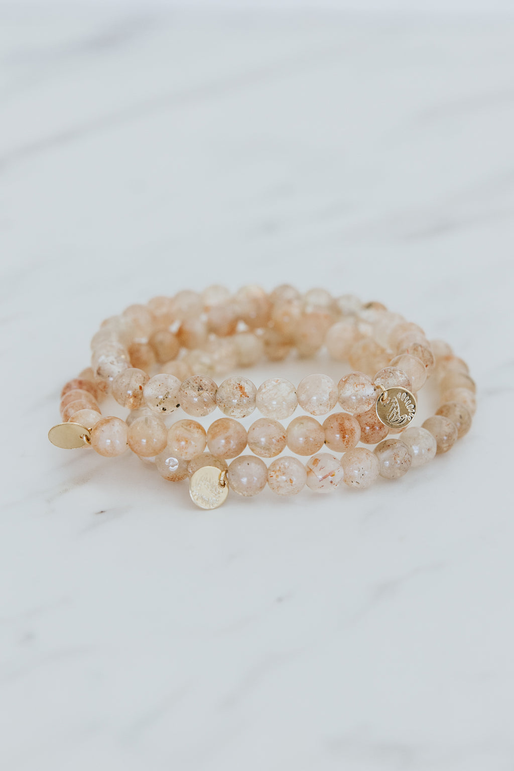 Wings Hawaii Sunstone stretchy beaded bracelet with 14k gold-filled tag. Crystal chakra healing. Boho-chic spiritual jewelry handmade in Maui.
