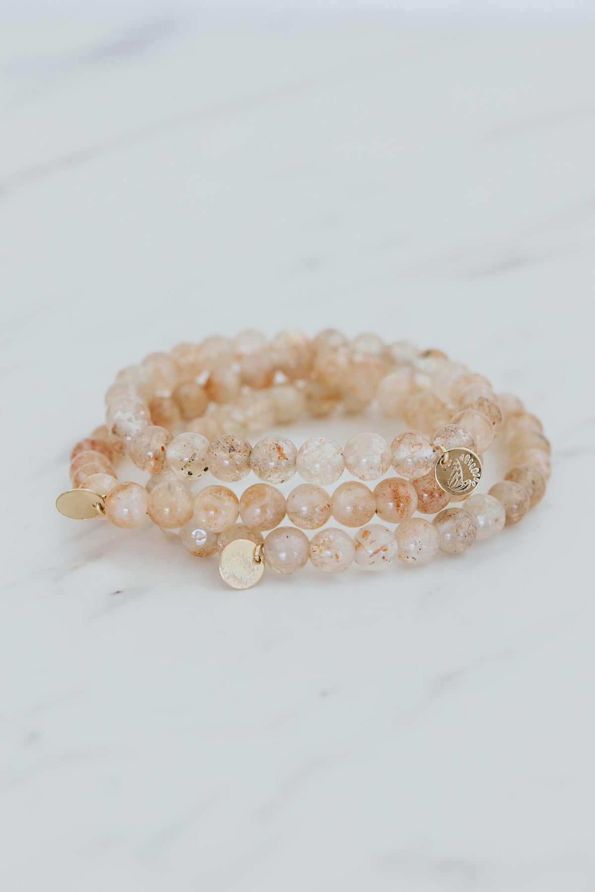 Wings Hawaii Sunstone stretchy beaded bracelet with 14k gold-filled tag. Crystal chakra healing. Boho-chic spiritual jewelry handmade in Maui.
