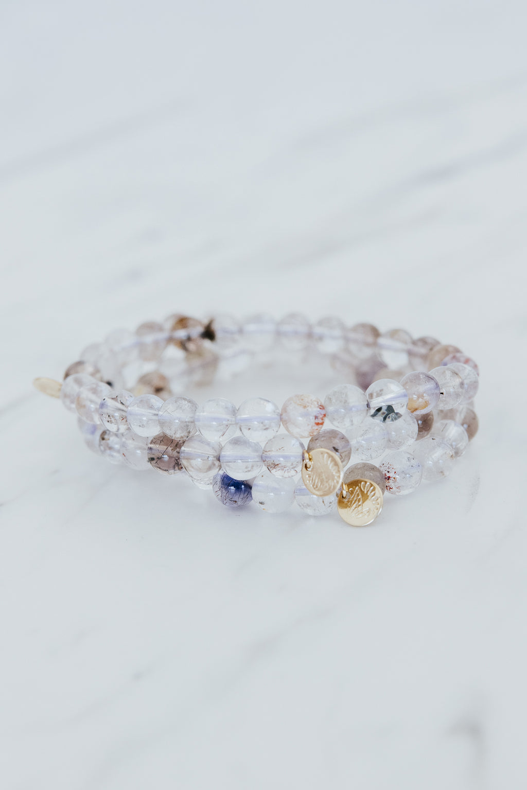 Wings Hawaii Light Super Seven stretchy beaded bracelet with 14k gold-filled tag. Crystal chakra healing. Boho-chic spiritual jewelry hand made in Maui.