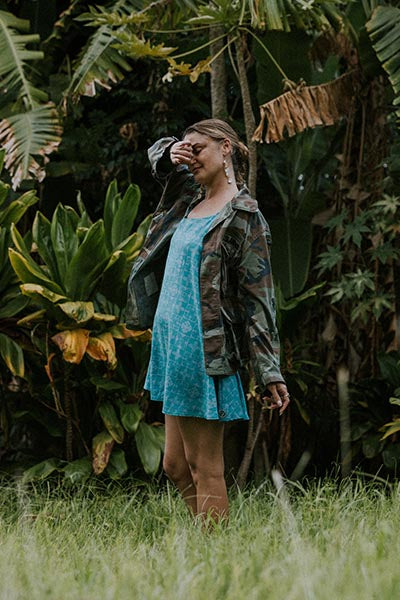 Wings Hawaii model wearing trapeze mini dress in ulu and plumeria print in blue surf