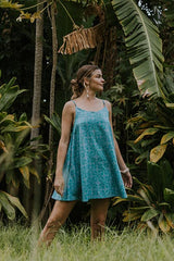 Wings Hawaii model wearing trapeze mini dress in ulu and plumeria print in blue surf thumbnail