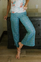 Model wearing Wings Hawaii pau hana pants in quilted ulu and plumeria print in surf blue  thumbnail