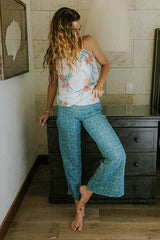 Model wearing Wings Hawaii pau hana pants in quilted ulu and plumeria print in surf blue  thumbnail