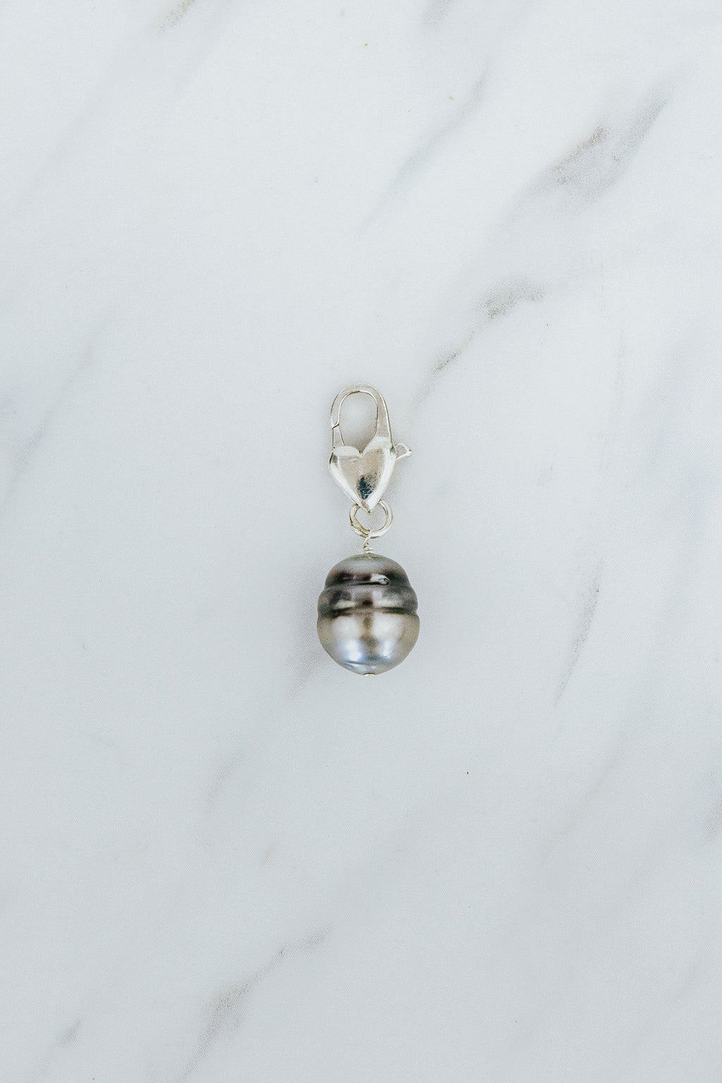 Wings Hawaii Tahitian Pearl necklace charm with heart-shaped clasp in sterling silver. Fine jewelry handcrafted in Maui. Modern, beachy boho chic charm necklaces made in Hawaii
