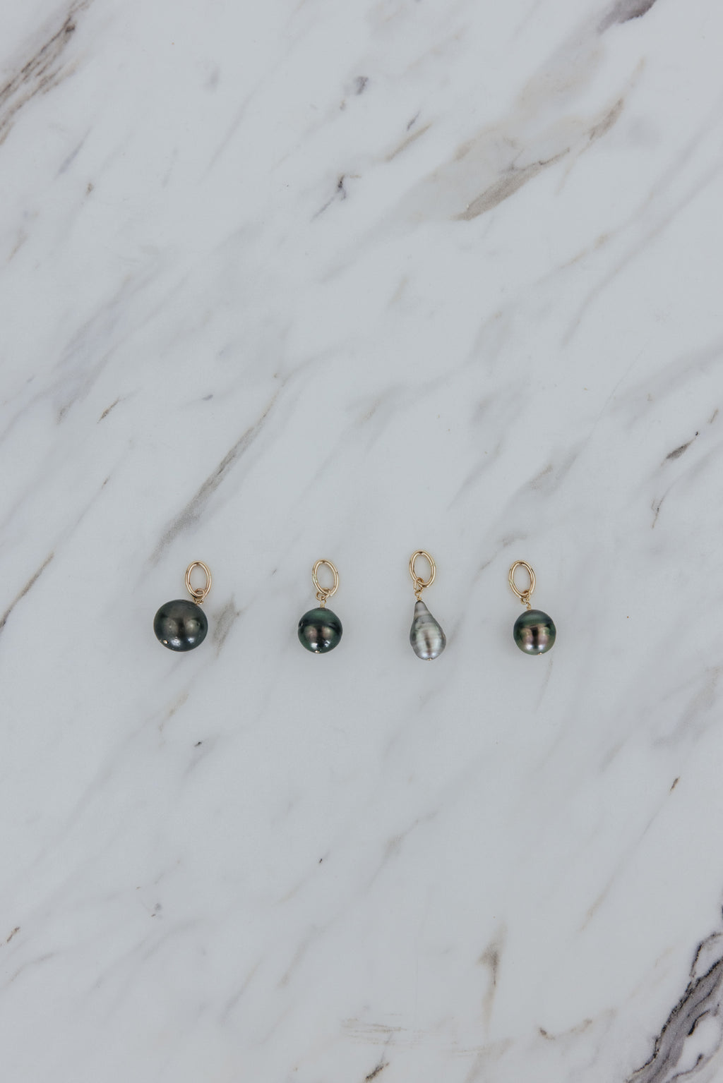 Wings Hawaii Tahitian pearl necklace charms in 14k gold-filled. Keshi teardrop, Baroque, and Round varieties. Fine jewelry handcrafted in Maui. Beach-chic charm necklaces handmade in Hawaii. 