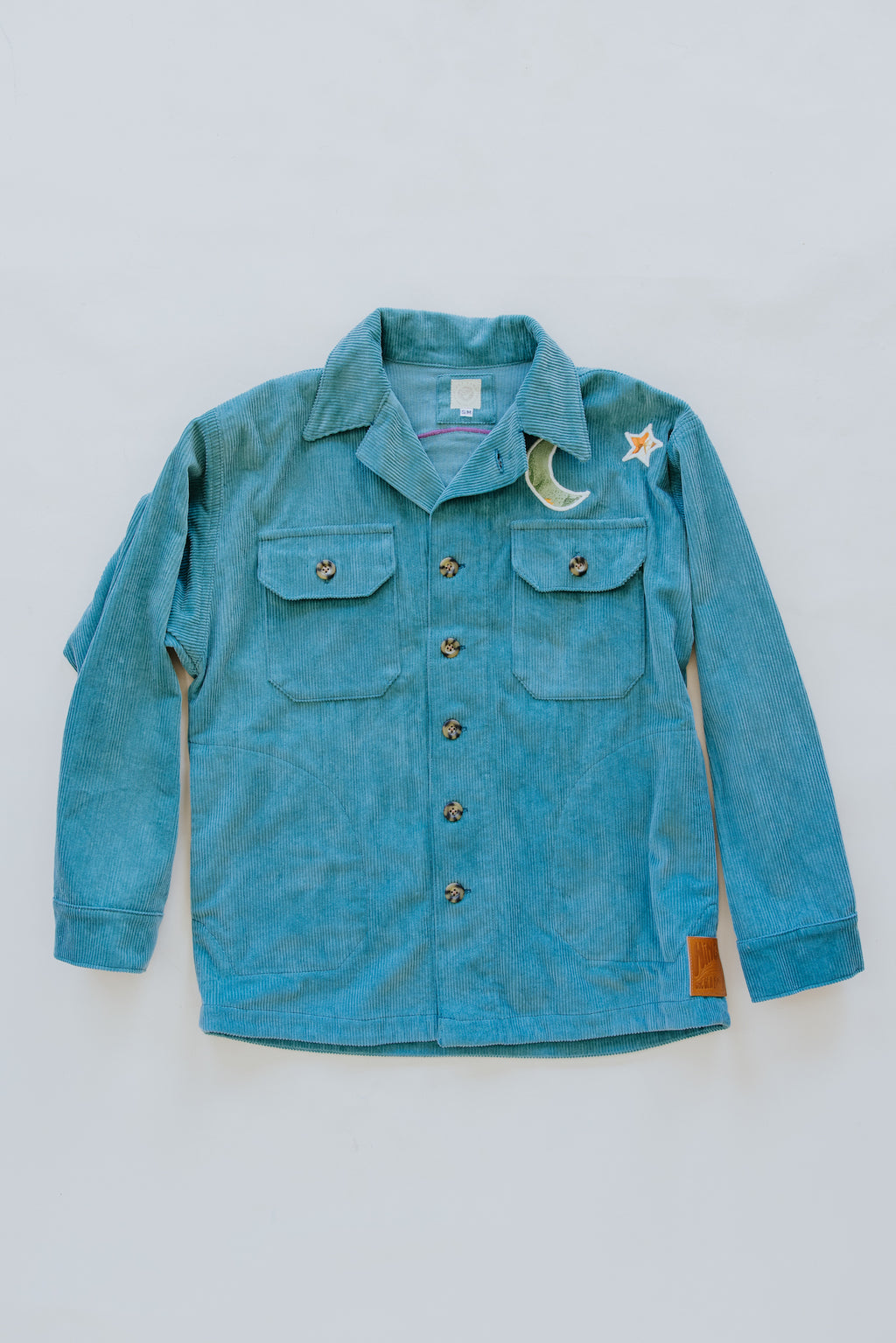 wings hawaii teal blue corduroy jacket with handmade patch. Vintage aloha print fabric upcycled into rainbow and stars design. Handmade in Maui. One of a kind. 
