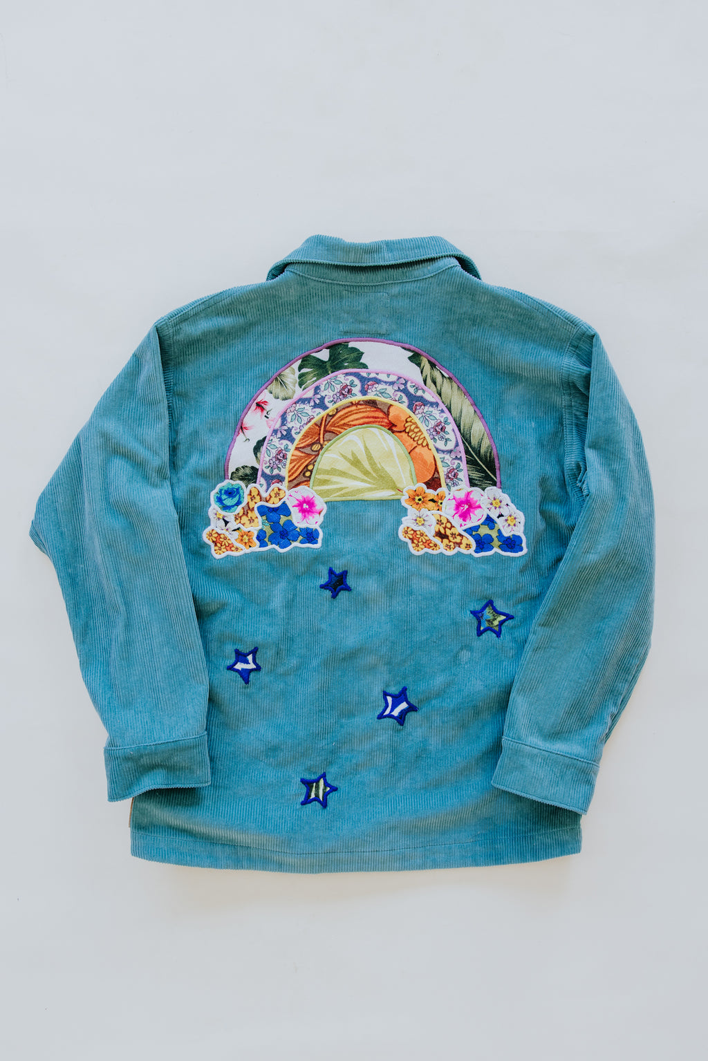 Wings Hawaii Rainbow Field Jacket. Teal blue oversized corduroy jacket with rainbow design in upcycled aloha fabric. Handmade and hand-sewn in Haiku, Maui. Perfect beach coverup or winter layer. One of a kind. 