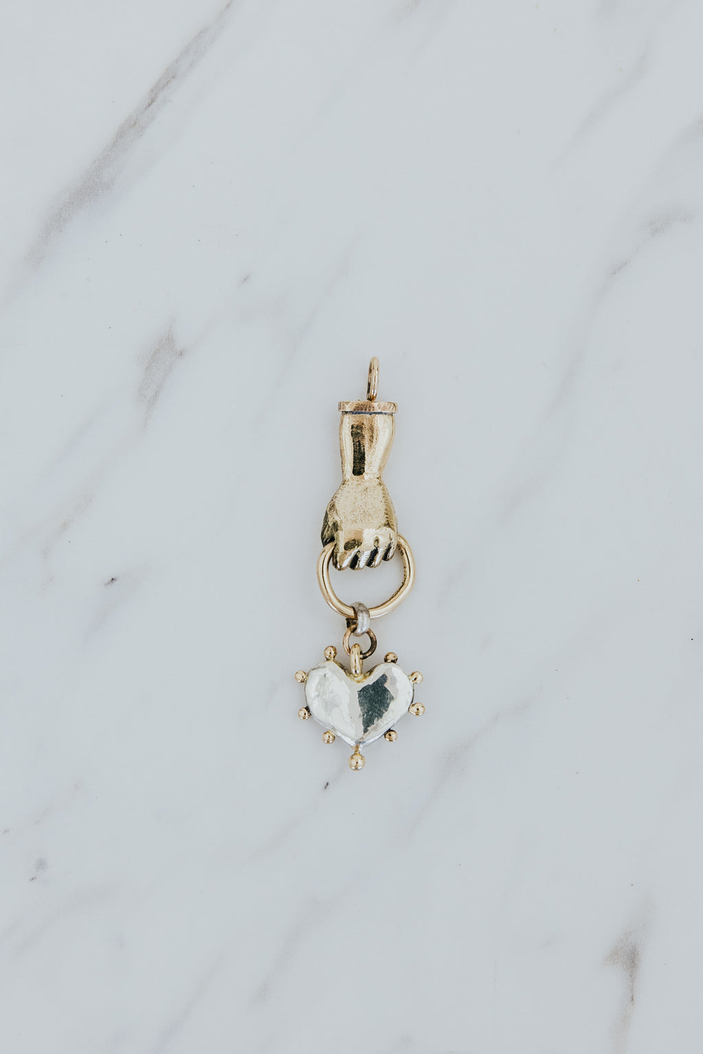 Wings Hawaii Stolen Heart necklace charm in solid 14k yellow gold and sterling silver. Hand-carved. Fine jewelry expertly handmade in Maui. 