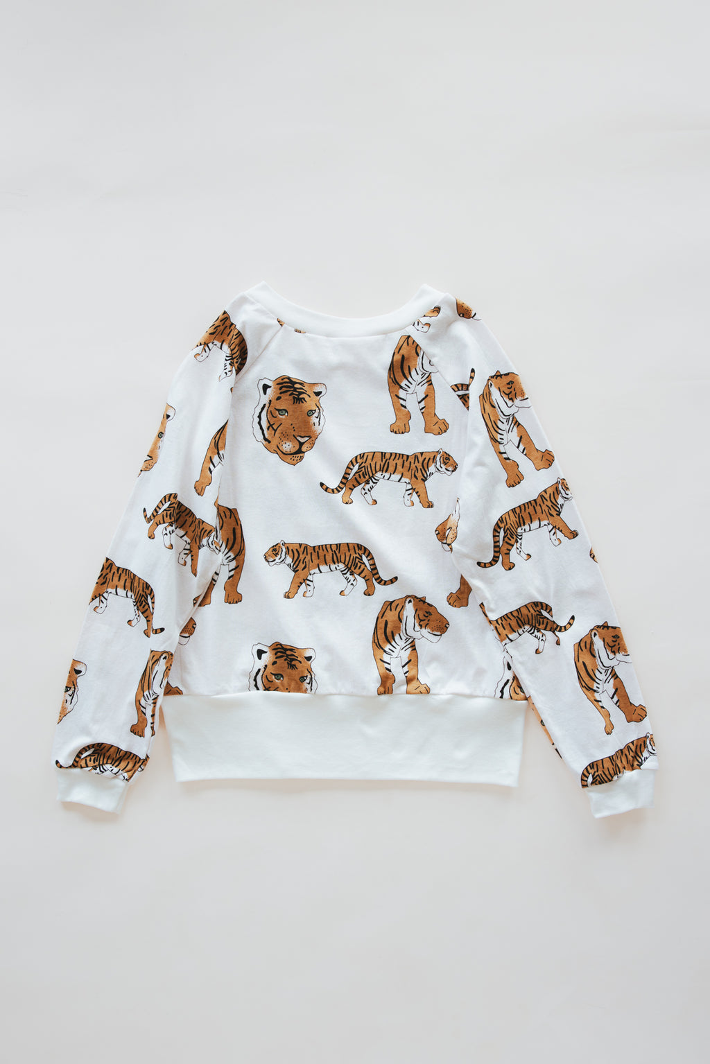Wings Hawaii women's Wandering Tiger print raglan. Crew neck, long sleeve, lightweight top. Original artwork designed in Maui, made in Bali. Small batch, sustainable, eco-conscious apparel. 