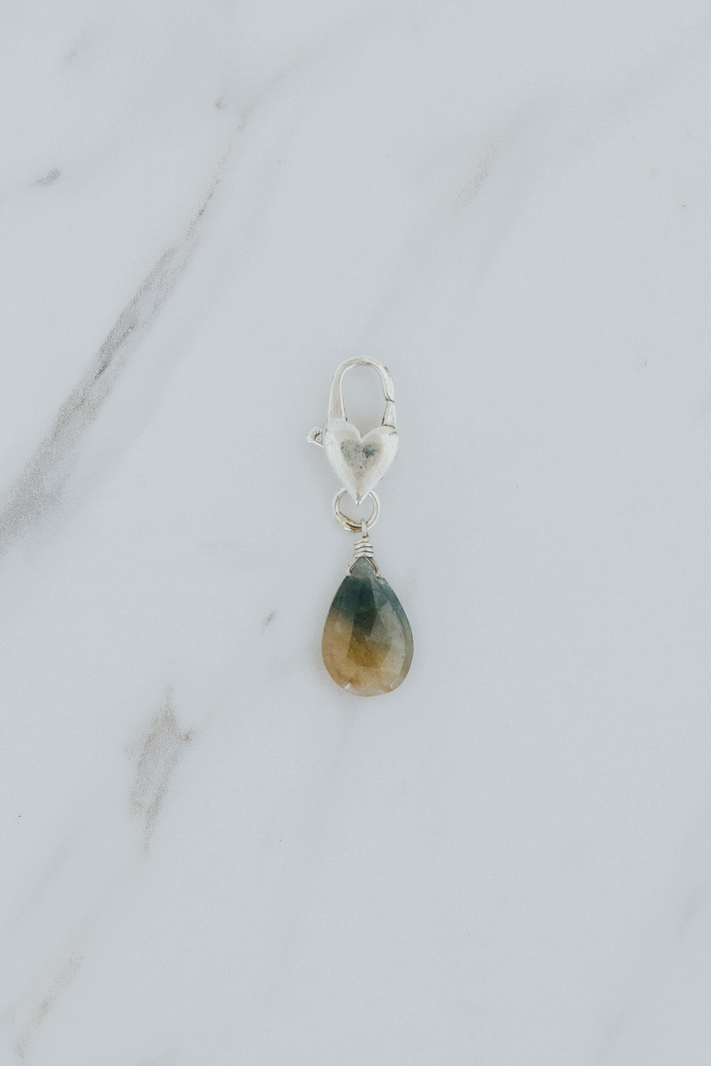Wings Hawaii Sapphire necklace charm with heart-shaped sterling silver clasp. Fine jewelry handcrafted in Maui. Modern, beachy boho chic charm necklaces made in Hawaii