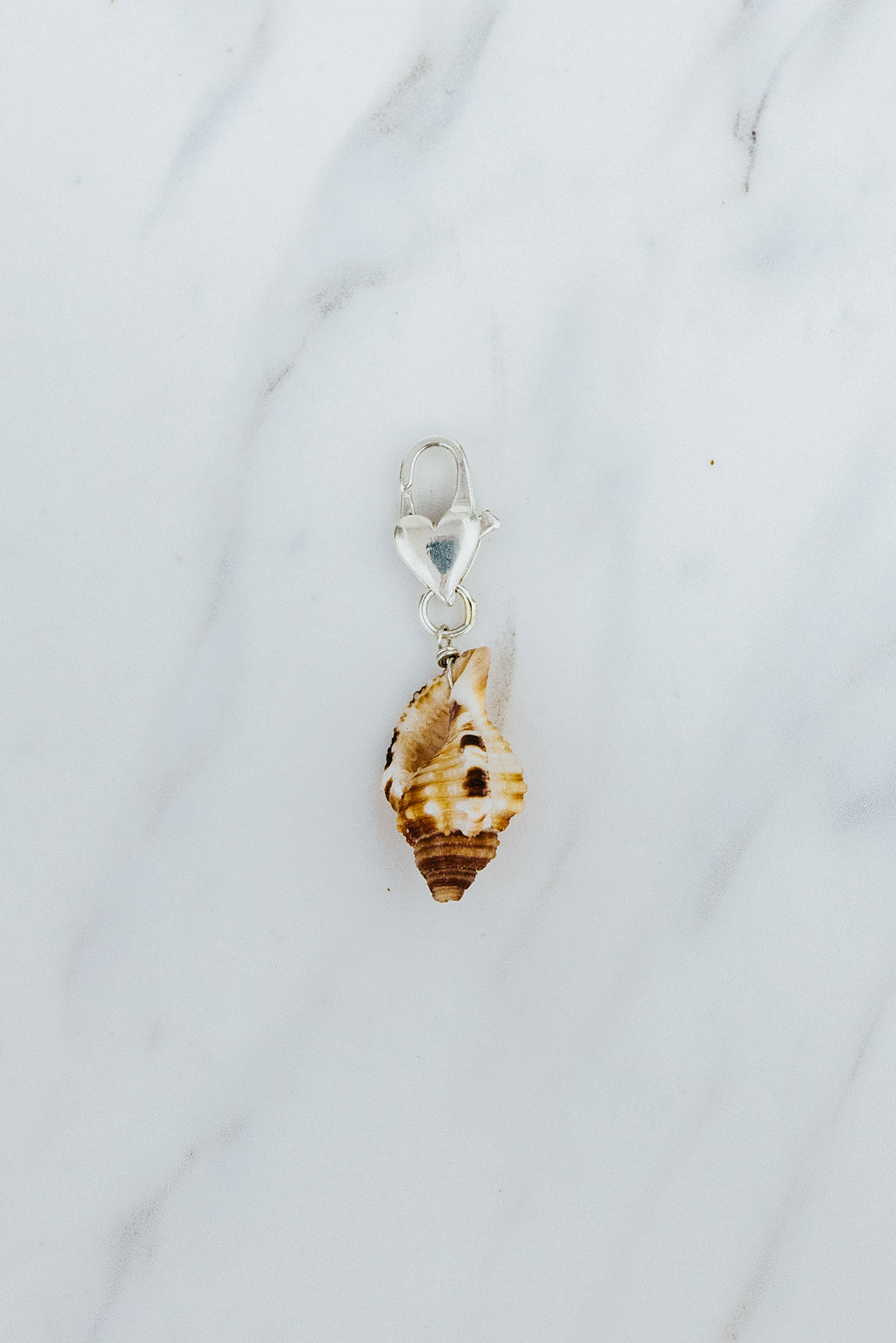Wings Hawaii Triton Shell necklace charm with heart-shaped clasp  in sterling silver. Fine jewelry handcrafted in Maui. Modern, beachy boho chic charm necklaces made in Hawaii