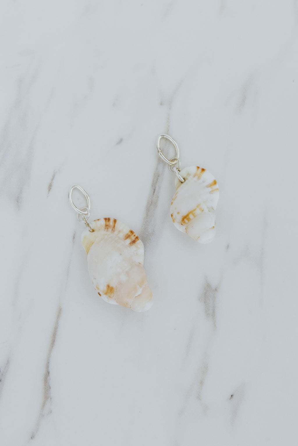 Wings Hawaii Triton  Shell necklace charms in sterling silver. Fine shell jewelry handcrafted in Maui. Modern beachy charm necklaces handmade with authentic Hawaiian sea shells. 