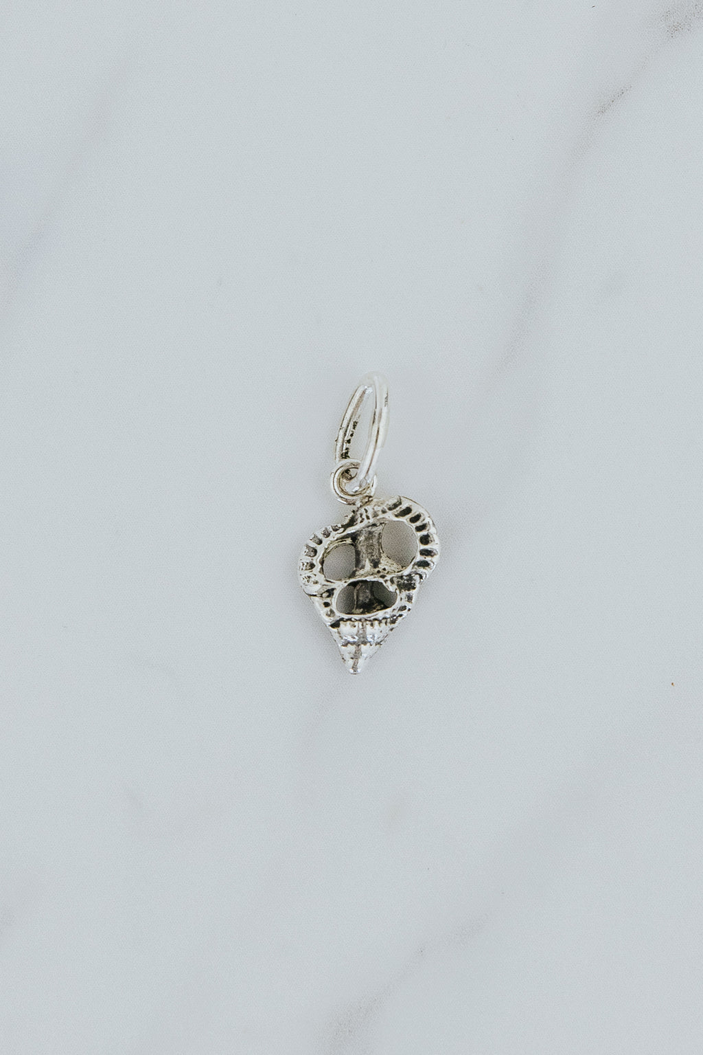 Wings Hawaii Forever Triton Shell cross-section necklace charm in sterling silver or solid 14k yellow gold. Fine jewelry handcrafted in Maui. Modern charm necklaces handmade in Hawaii.  