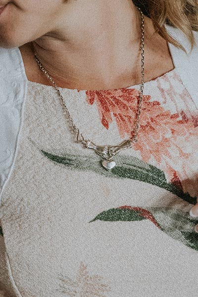 Model wearing Wings Hawaii Stolen Heart Necklace in sterling silver