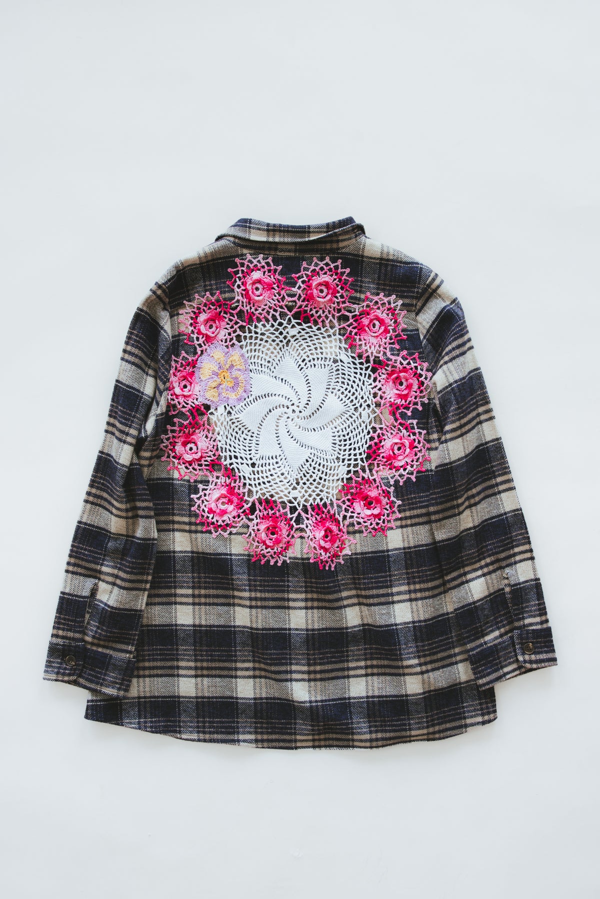 Wings Hawaii Paragon Flannel. 100% cotton button-up flannel with side pockets. Vintage crochet lace doily on back. Sewn in LA, designed and upcycled in Maui. 