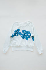 Wings Hawaii women's Hibiscus Raglan sweatshirt. White with blue vintage tropical floral print. Designed in Maui, made in Bali. Small batch, sustainable, eco-conscious clothing.  thumbnail
