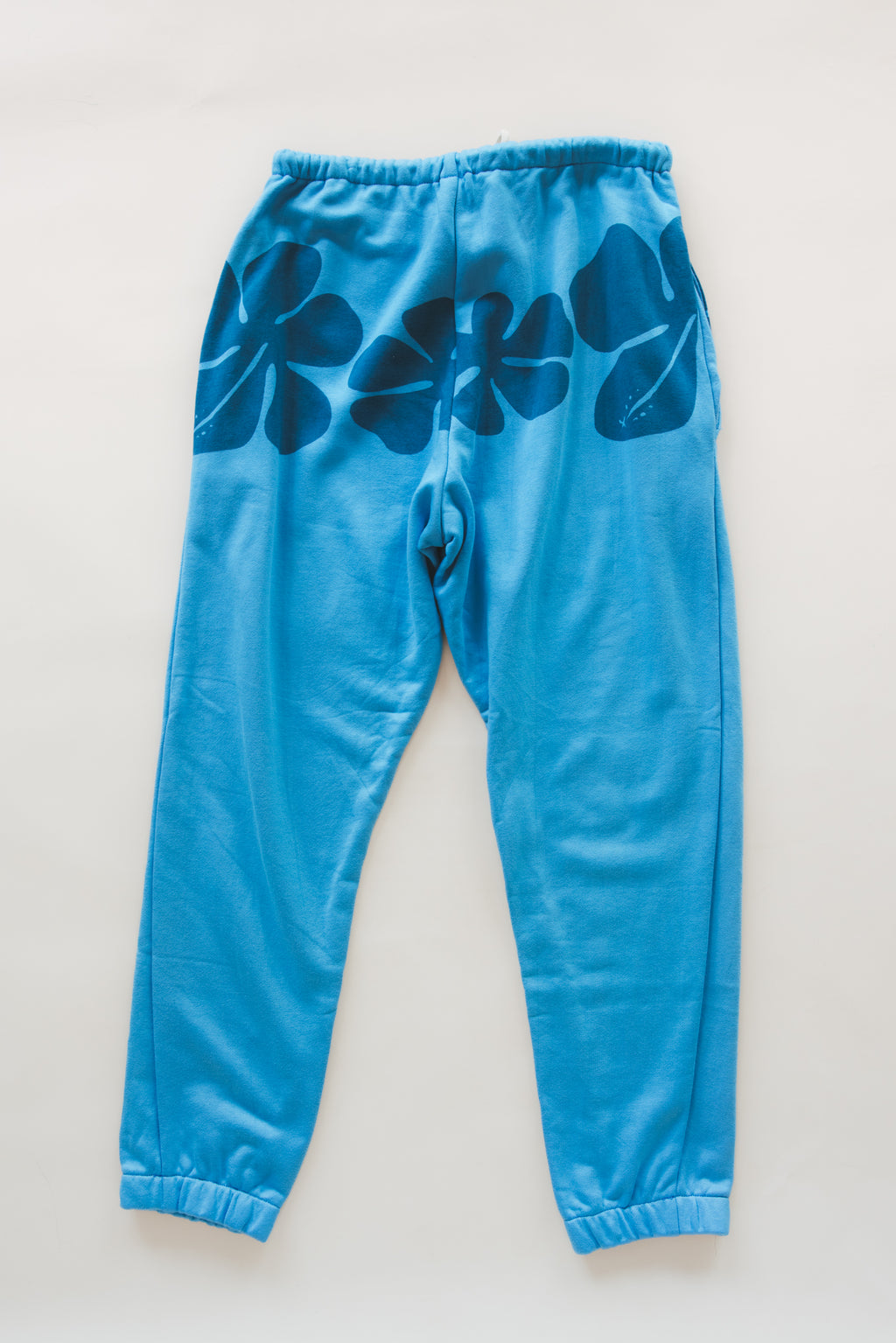 Wings Hawaii blue hibiscus joggers in bamboo french terry. Elevated loungewear  pants. Original artwork designed in Maui, hand sewn in Bali in small batches. Drawstring waist, mid-rise, pockets. 
