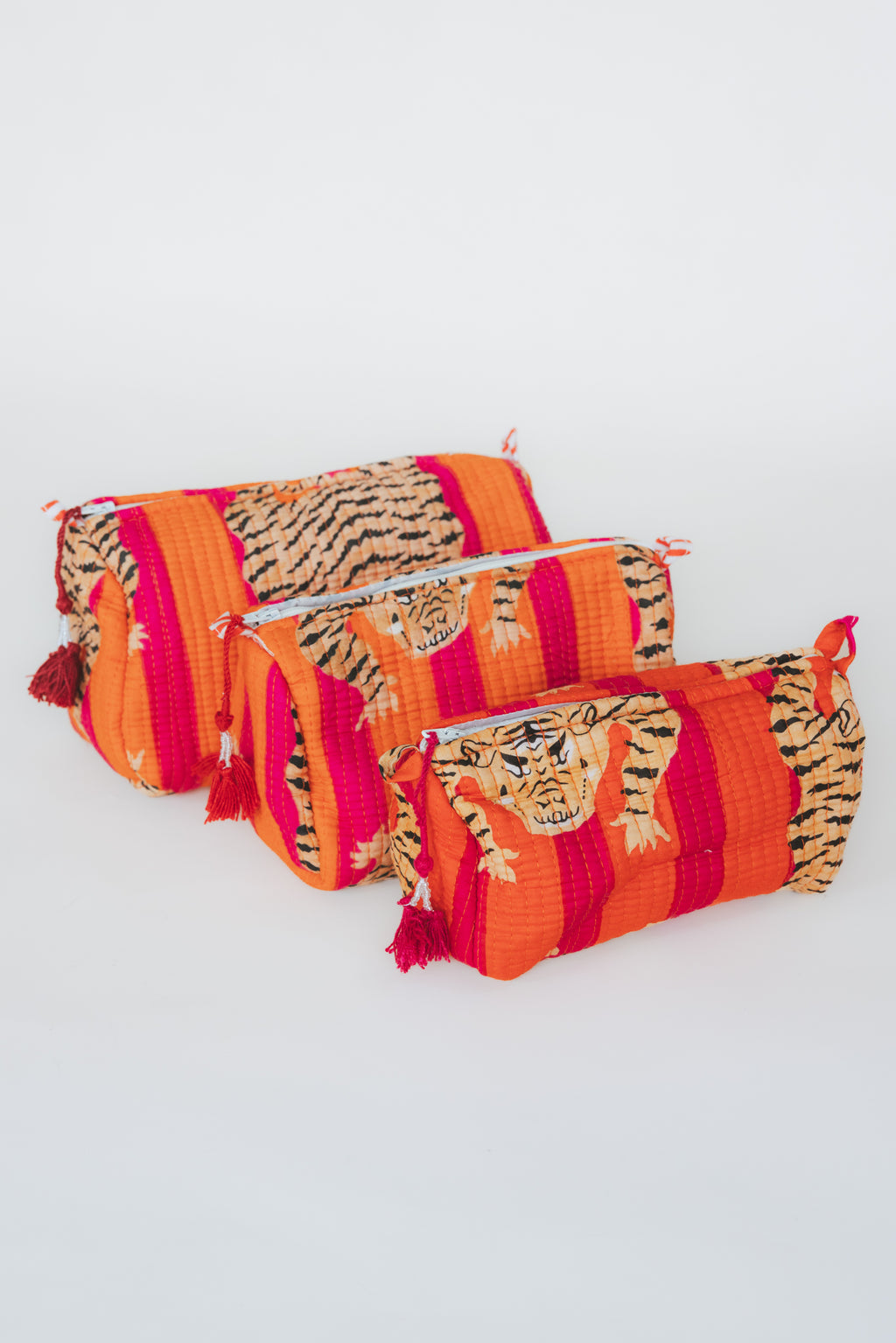 Wings Hawaii vintage kantha toiletry pouches in three sizes. Tiger print on red/orange stripes. Stash your cosmetics and trinkets in these chic travel-sized pouches. They make great gifts too. 