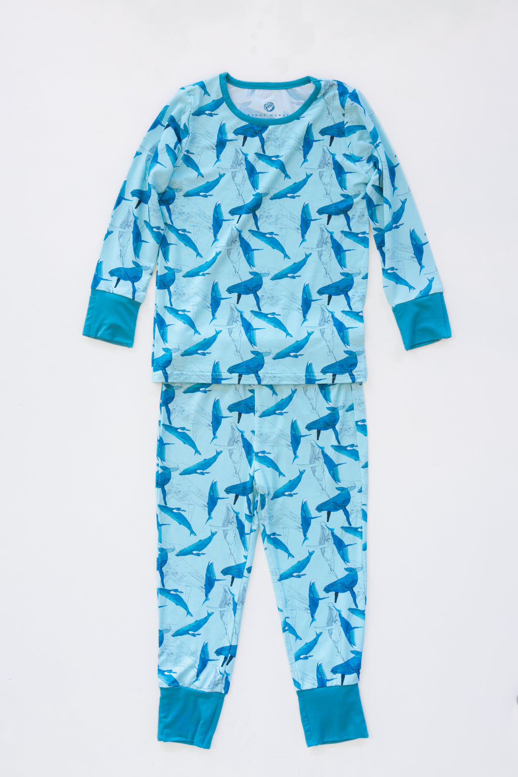 Wings Hawaii Kohola kids pajamas set with humpback whales print. Original artwork designed in Maui. Island style keiki gifts. Long sleeved shirt with pajama pants. Small batch, sustainable, unique children’s apparel. 