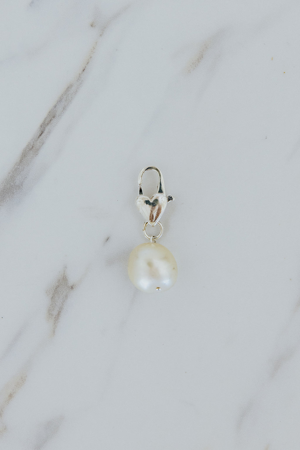 Wings Hawaii South Seas Pearl necklace charm with heart-shaped clasp  in sterling silver. Fine jewelry handcrafted in Maui. Modern, beachy boho chic charm necklaces made in Hawaii