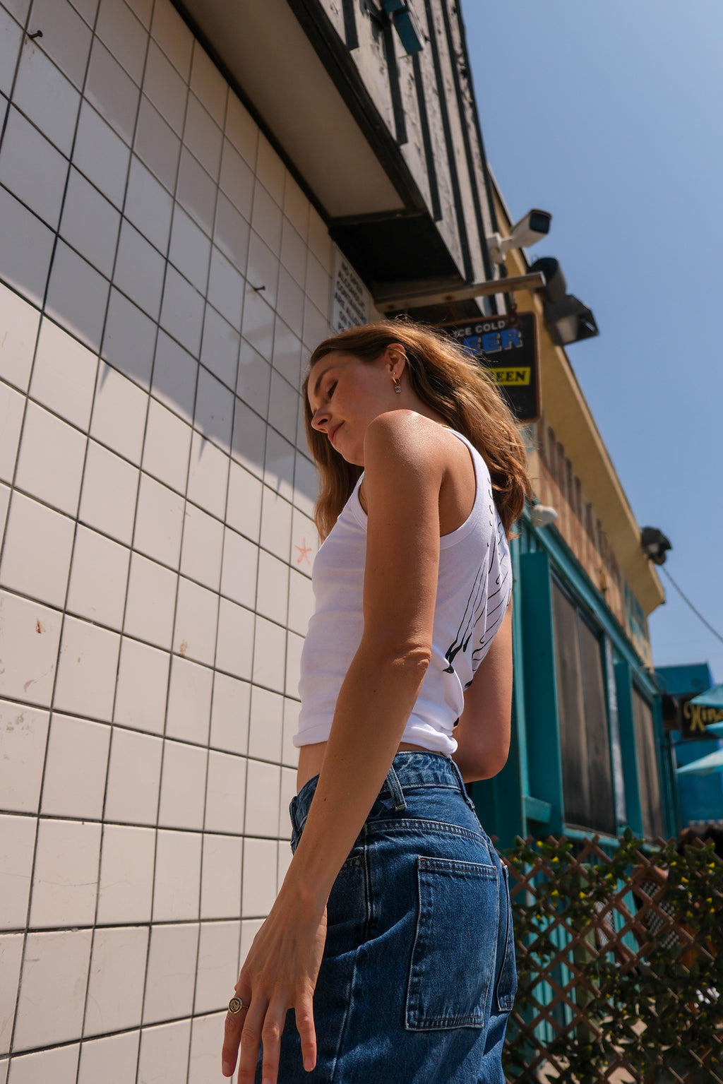 Wings Hawaii White Wing Tank. Angel wings in black print on white cotton tank top. Screenprinted by hand in Haiku, Maui. Original, sustainable, slow fashion made in Hawaii. 