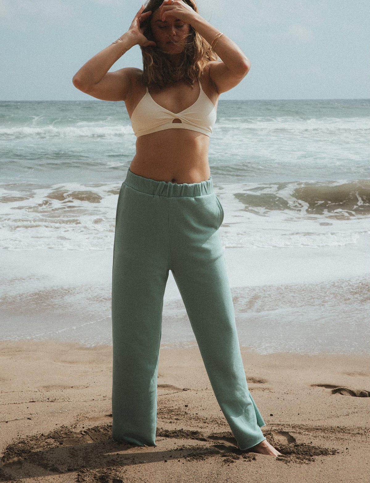 Model in beach pants at the shoreline
