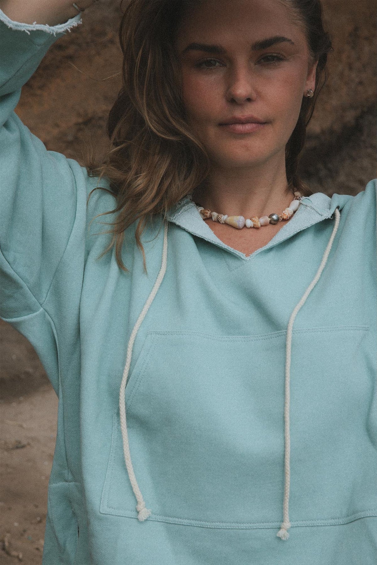Model in a mint hoodie