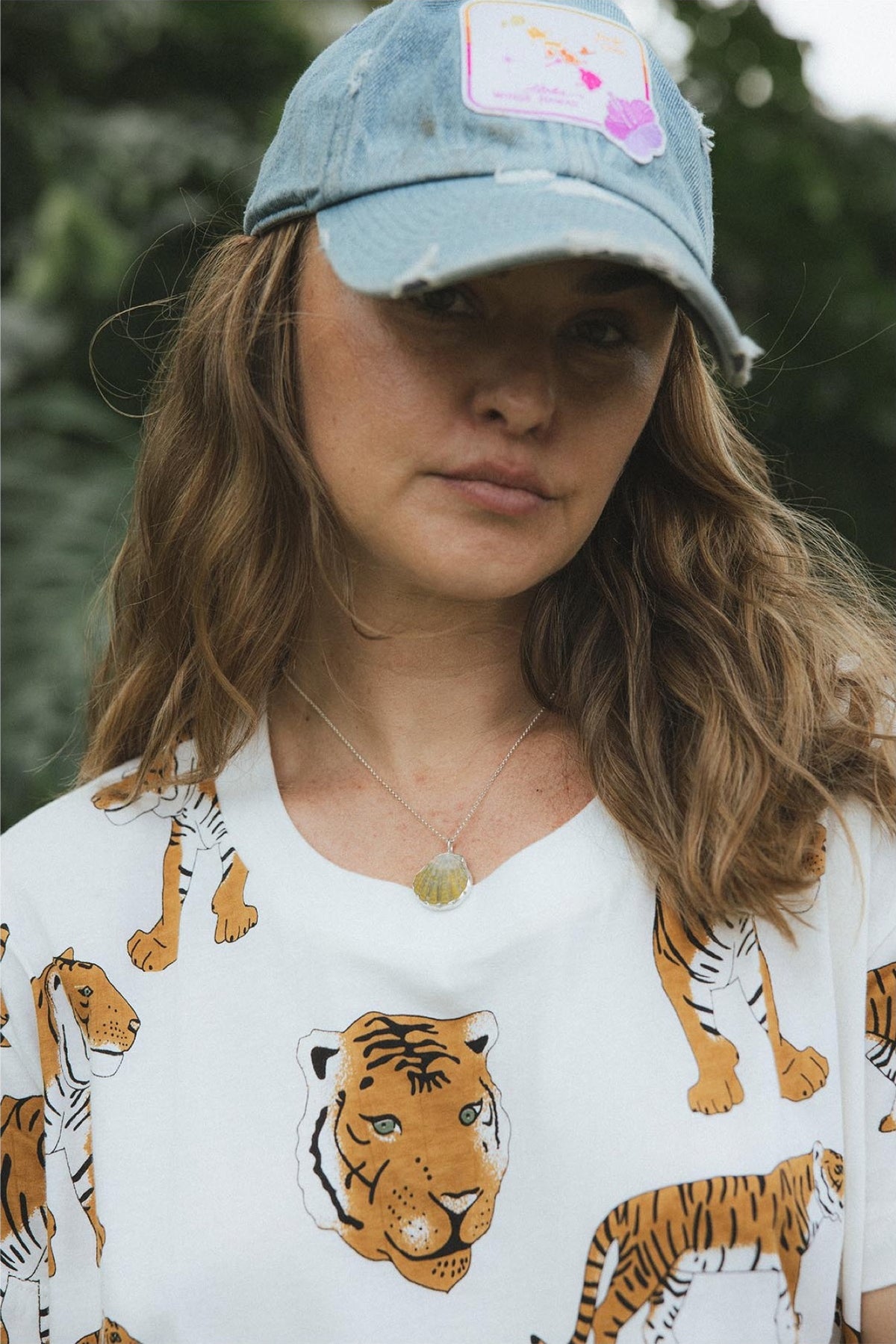 Model in a cap and tiger tee