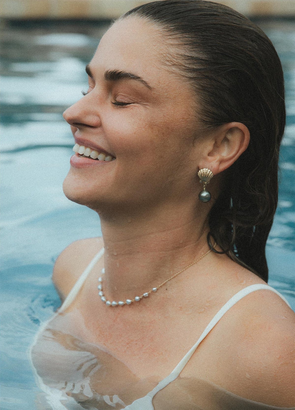Model smiling in the pool