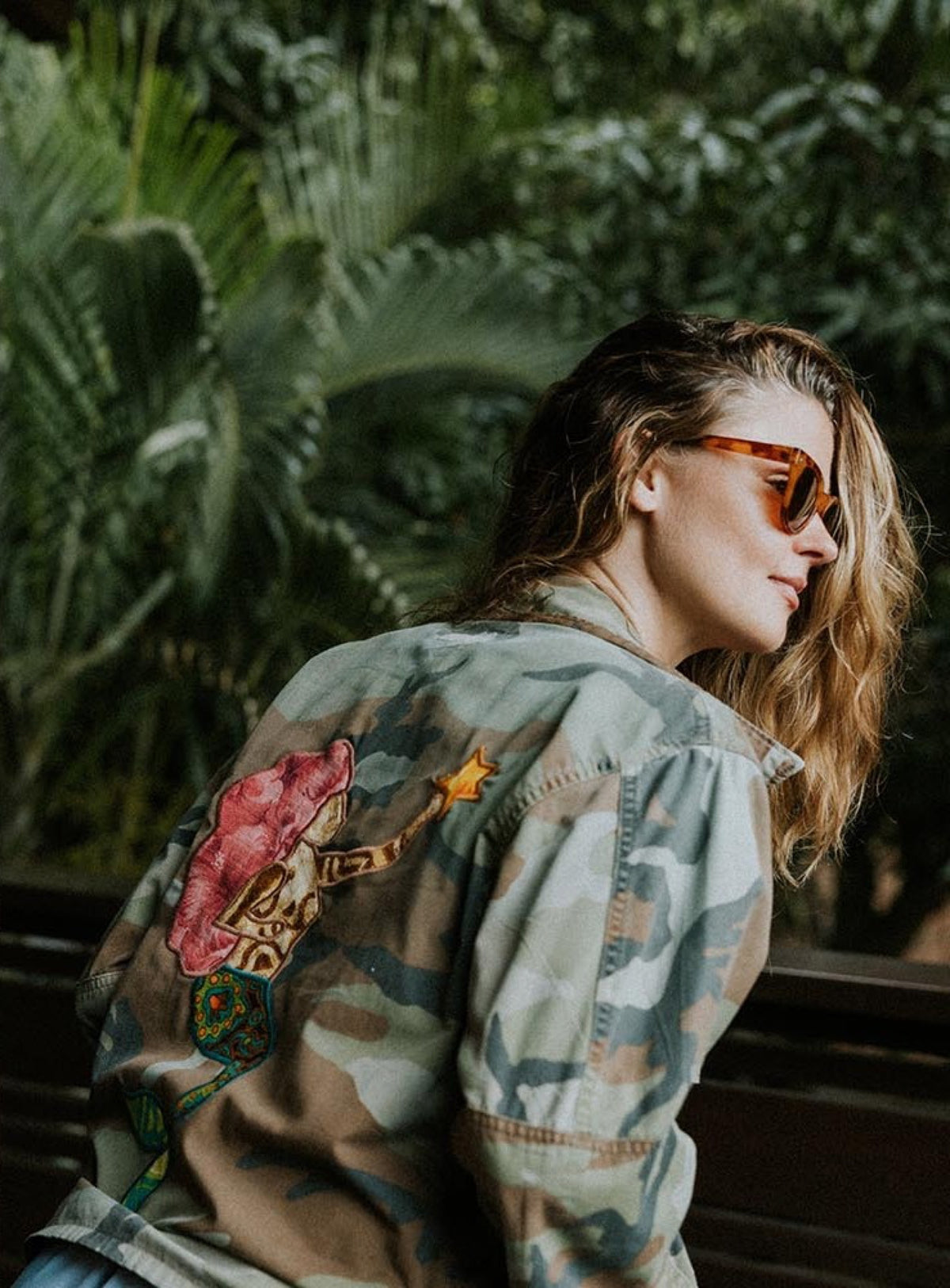 Back of a camo jacket with a floral patch