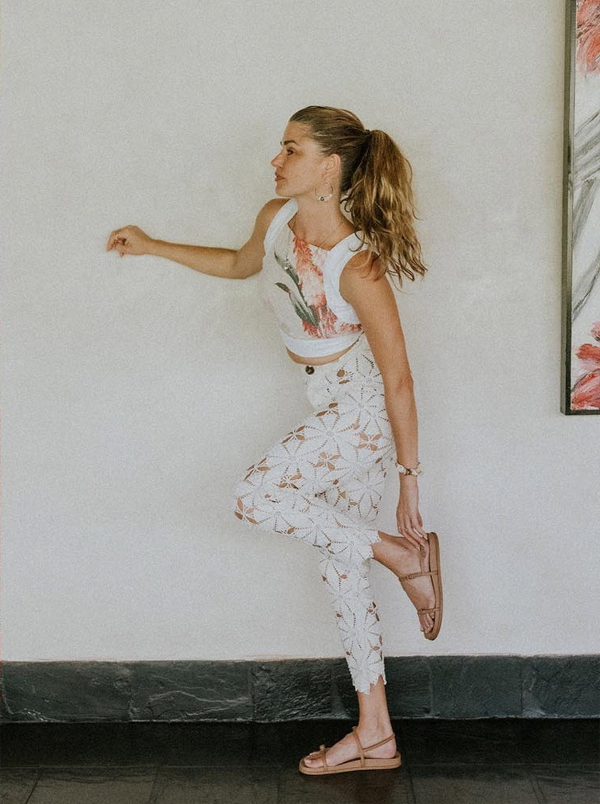 Model in a floral pinafore set mid-step