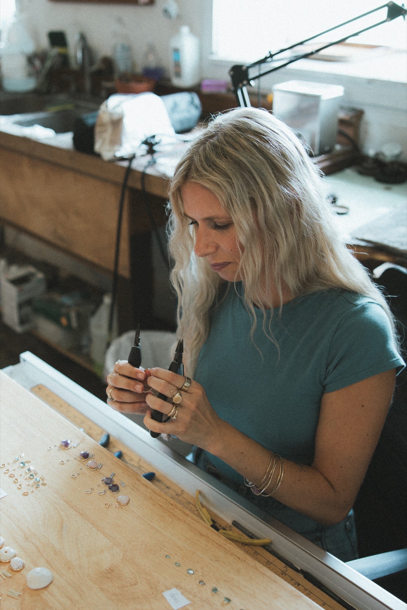 Artisan making jewelry at the studio bench
