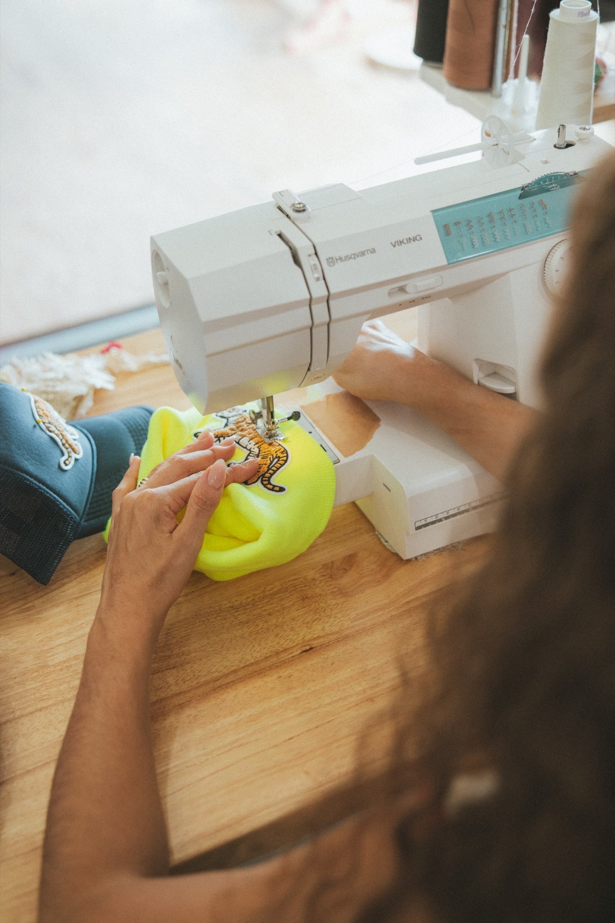 Sewing a tiger patch at the sewing machine