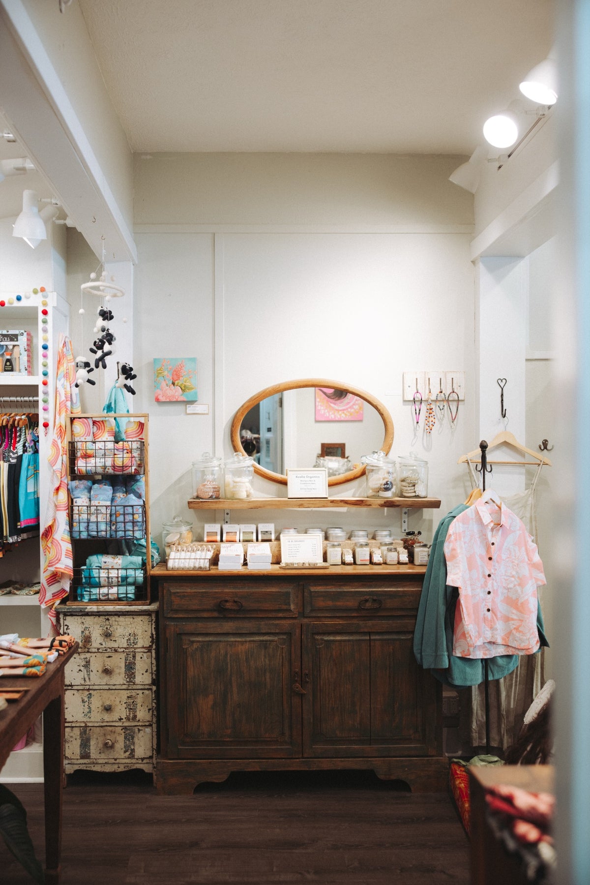 Inside the Wings shop: jewelry, clothing and a mirror over an old dresser